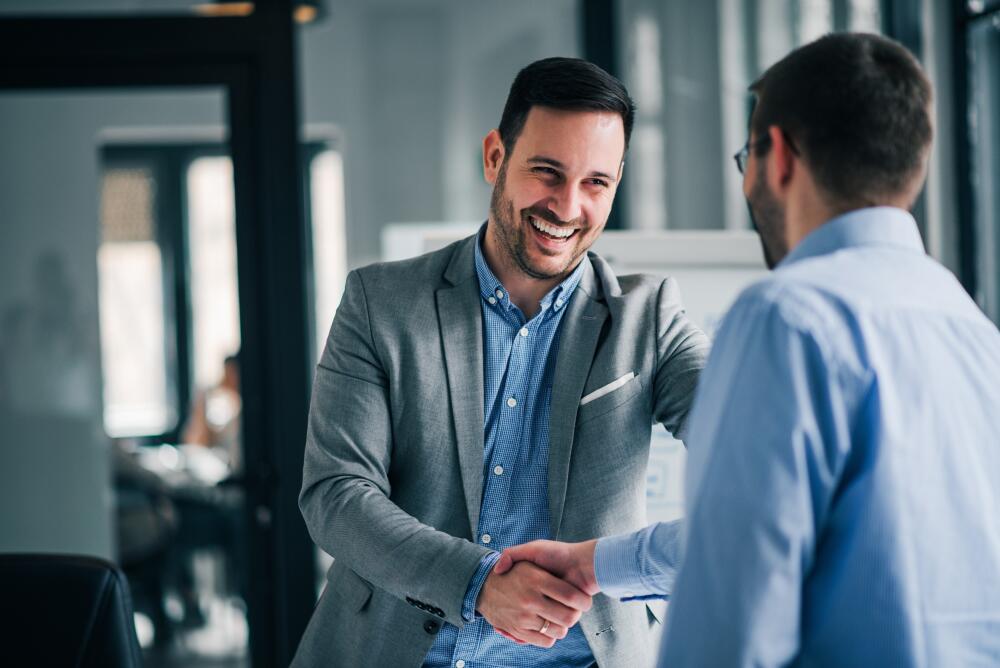 Two men shaking hands showcasing the appetite of Flowflex to work with partners and others.