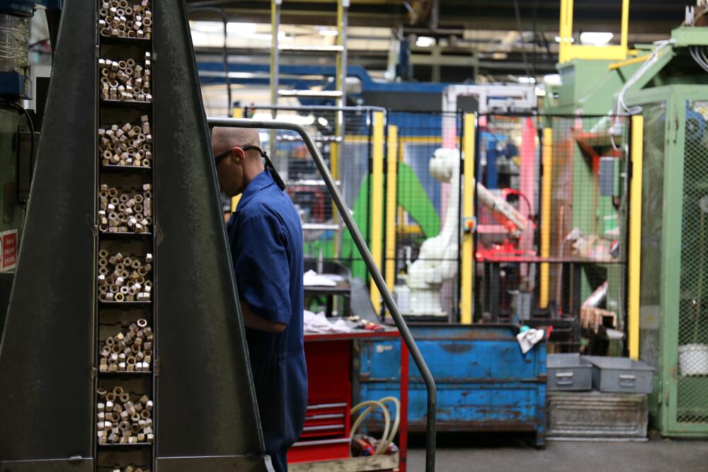 A Flowflex employee working with advanced machinery, illustrating the company’s dedication to engineering excellence and innovation.